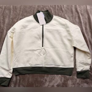 Fabletics Catarina Mock Neck Half Zip Pullover in cream and green.